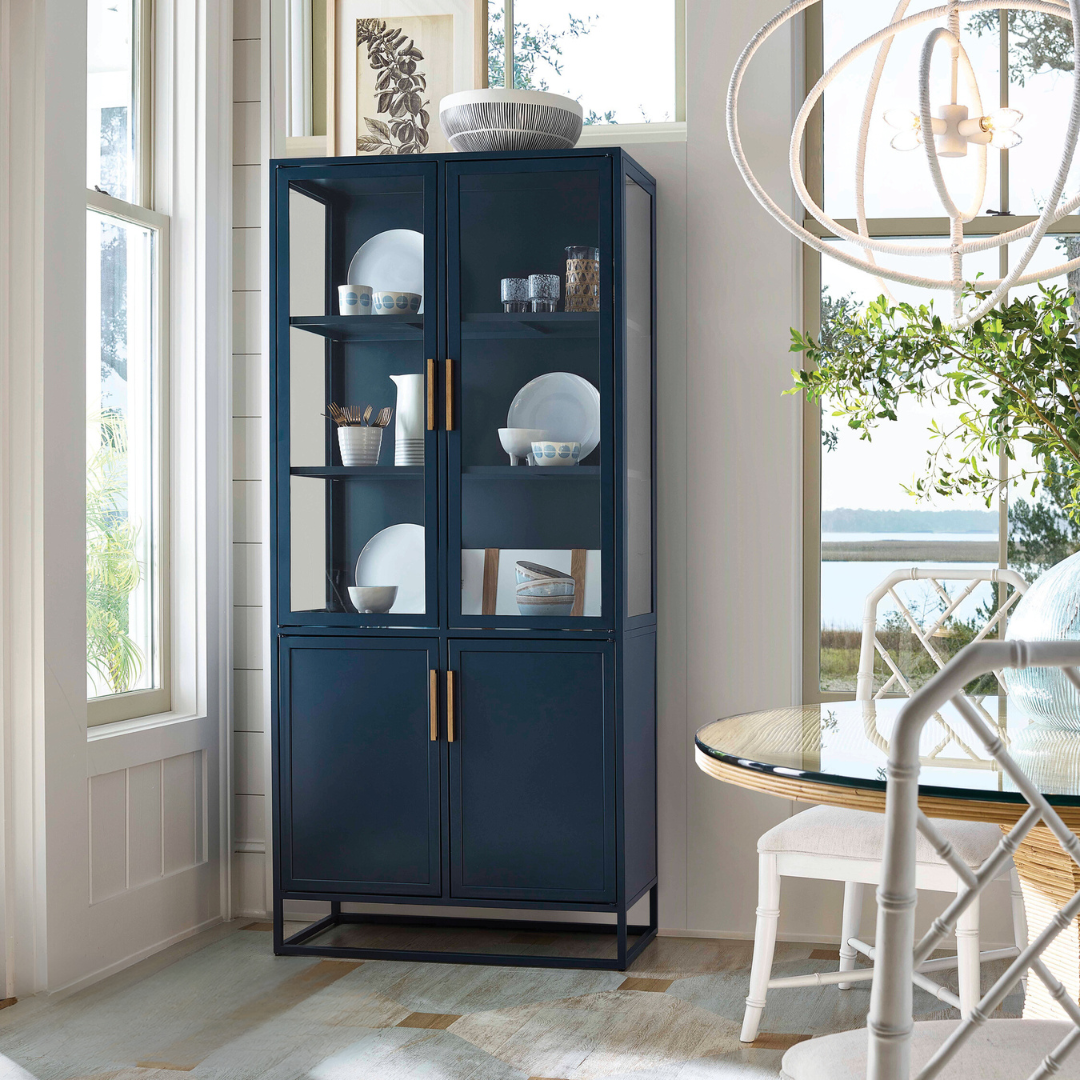 A blue china cabinet in a dining room.