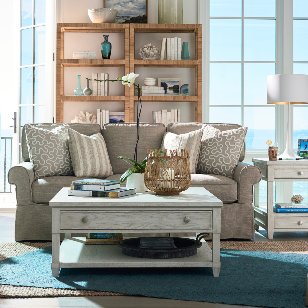 A living room with large windows and a white couch.