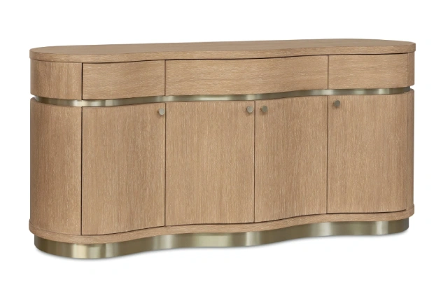 Curved light wood sideboard with brass accents on white background.