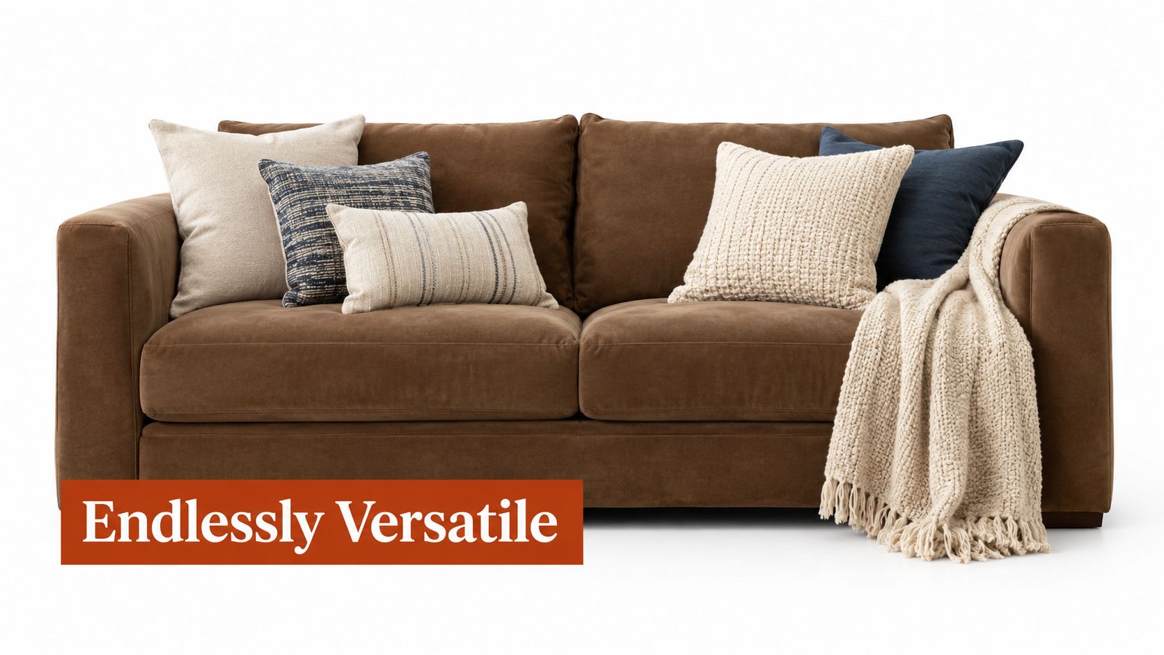 A brown microfiber couch decorated with various throw pillows and a beige knitted blanket on white background.