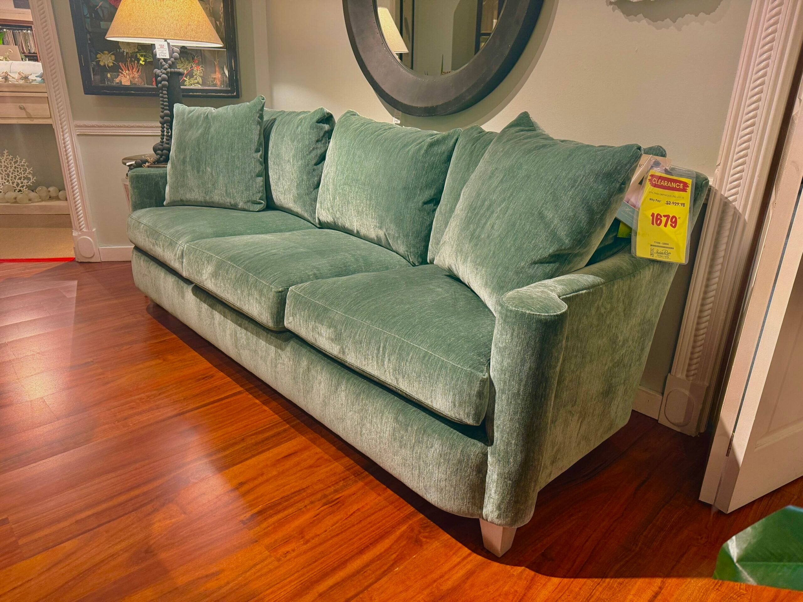 img_1767-2 A plush sage green velvet sofa with clearance tag.
