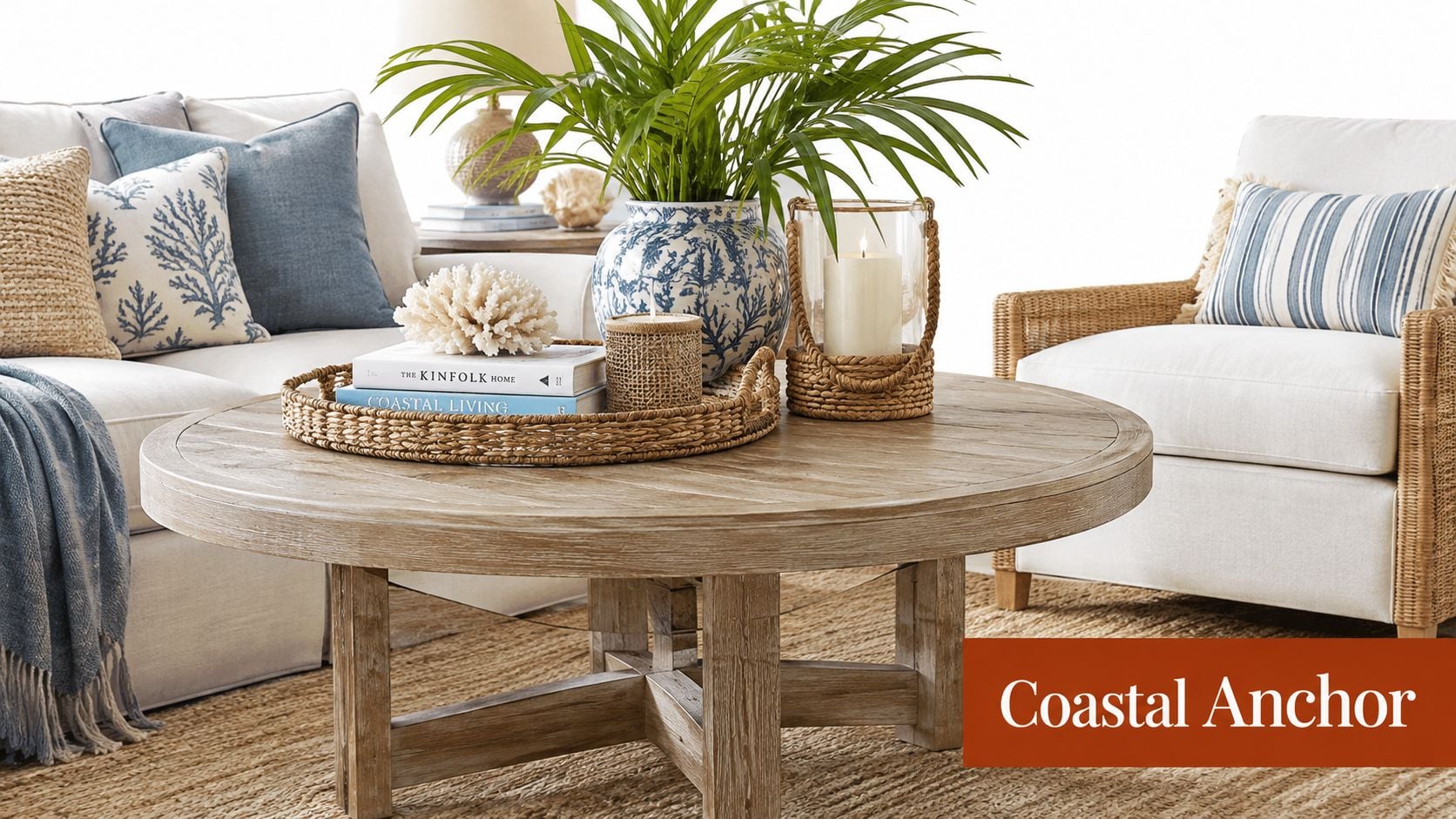 A coastal style living room featuring a round wooden coffee table, woven tray, and blue patterned decor.
