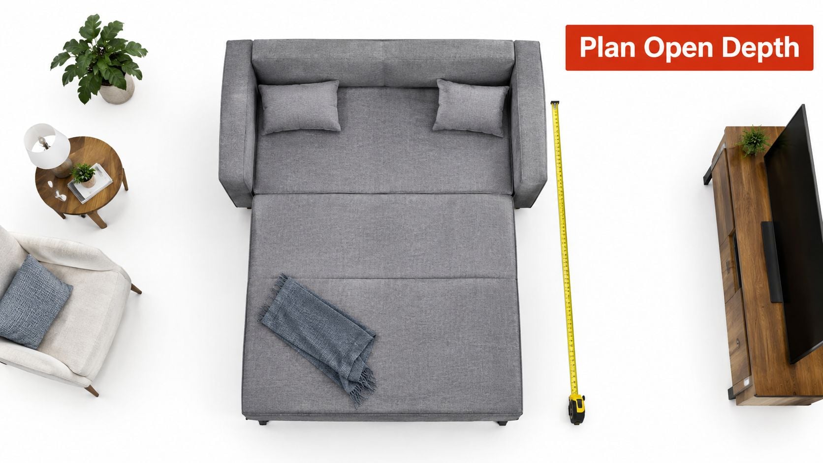 A top-down view of a modern gray sleeper sofa fully extended into a bed with a measuring tape.