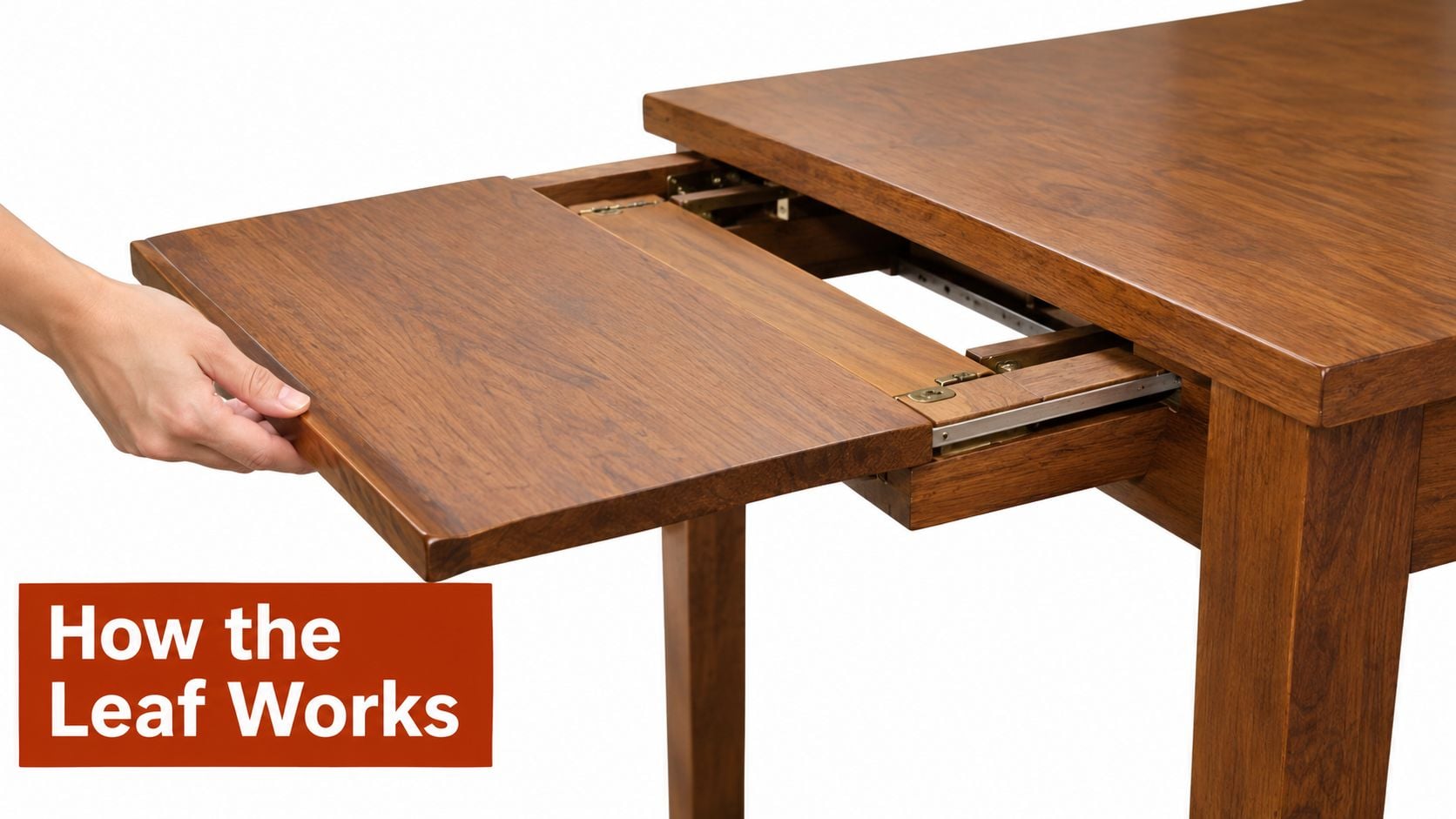 A hand pulls out a self-storing extension leaf from a wooden square dining room table.